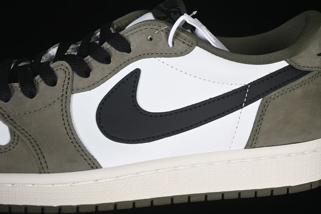 Close-up of the black Swoosh, white side panel, and olive overlays