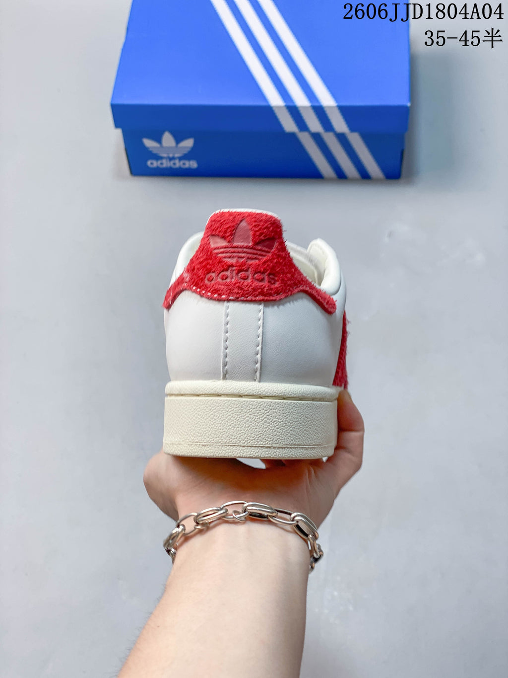 Rear view showing the red heel detail and off-white sole.