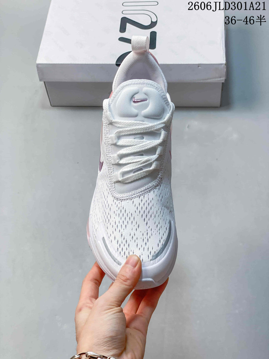 Front view of the white mesh-look upper and lace-up design