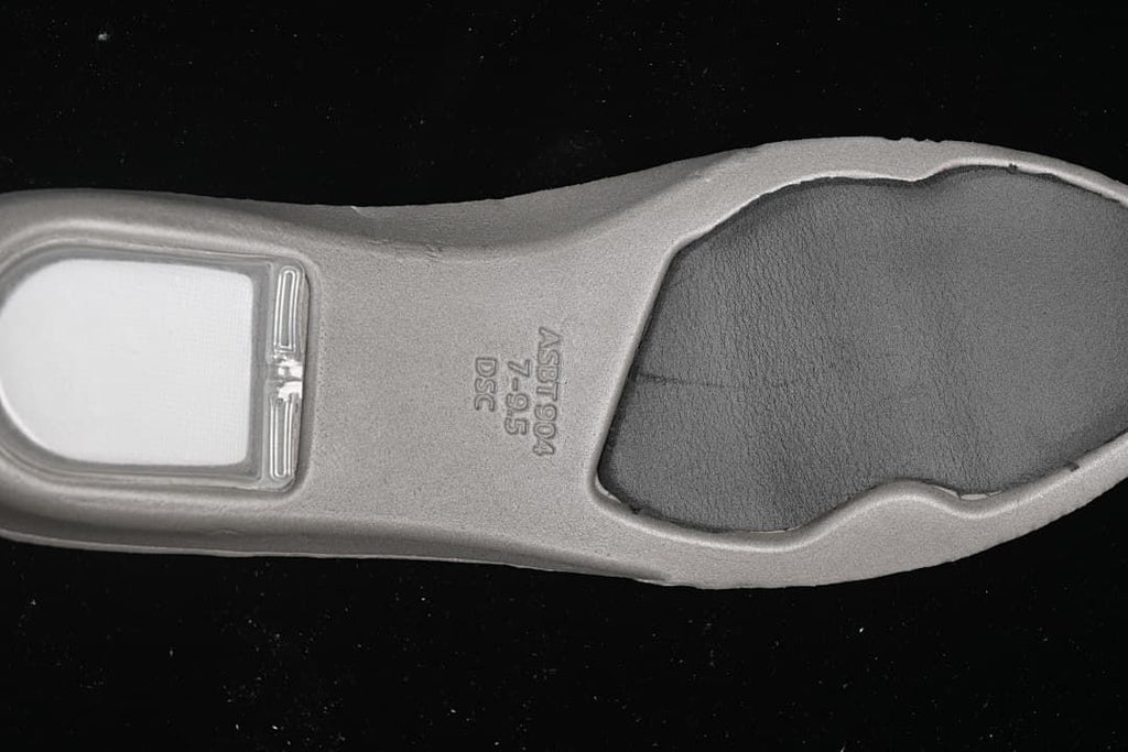 Close-up of the sneaker insole underside with embossed markings
