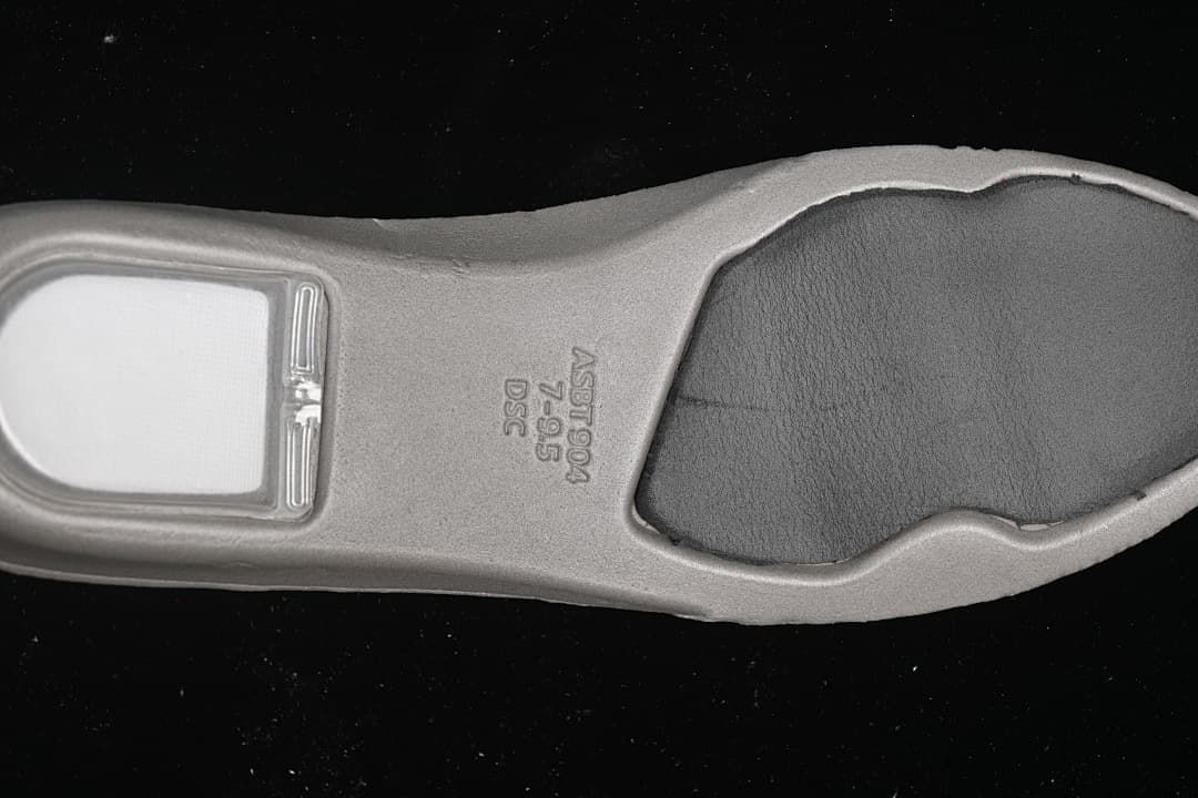 Close-up of the sneaker insole underside with embossed markings