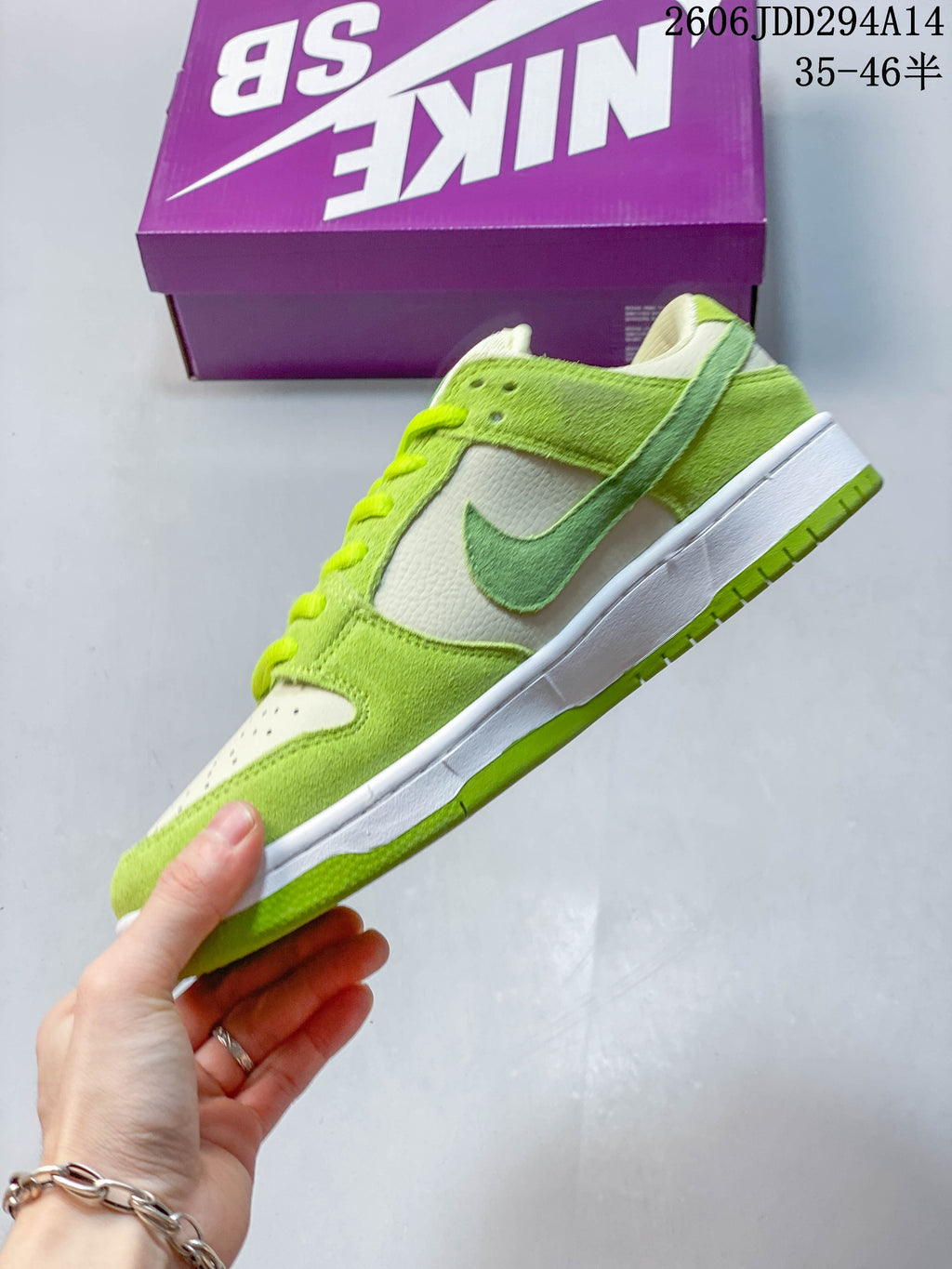 Side view of a lime-green and white Nike Dunk Low SB sneaker