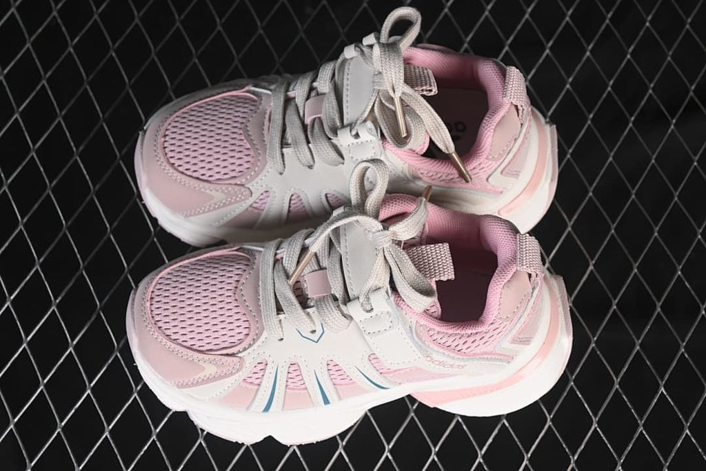 Pair of pink and off-white kids sneakers viewed from above