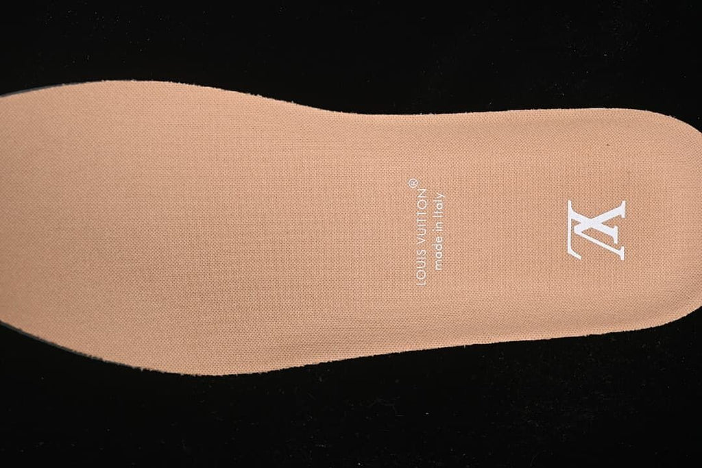 Tan-colored shoe insert with printed Louis Vuitton branding