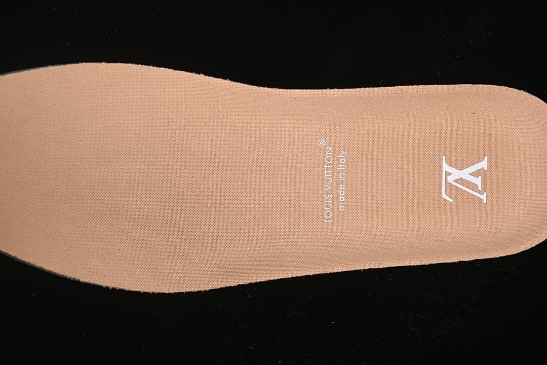 Tan-colored shoe insert with printed Louis Vuitton branding