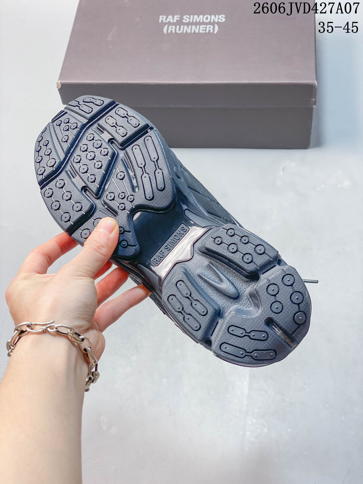 Outsole of a charcoal Raf Simons sneaker showing its molded tread pattern
