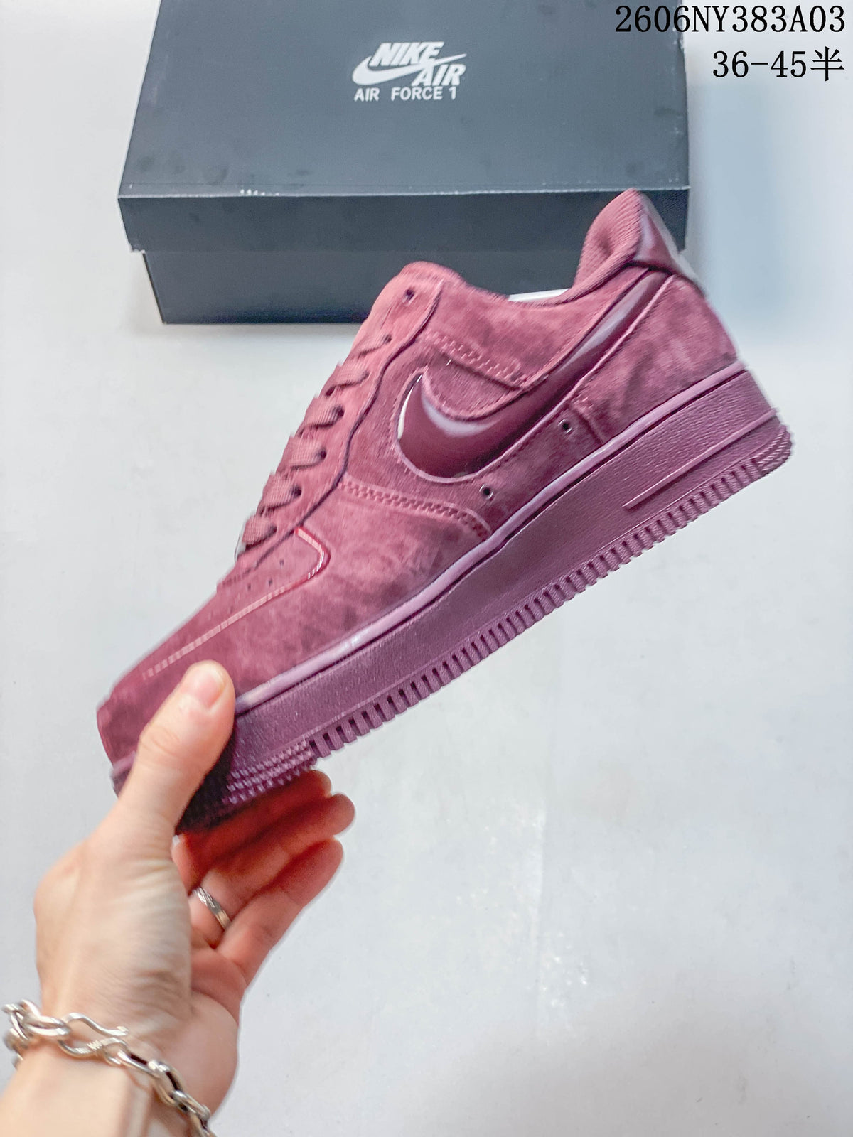 Side profile of a dusty rose low-top sneaker with a contrasting Swoosh detail
