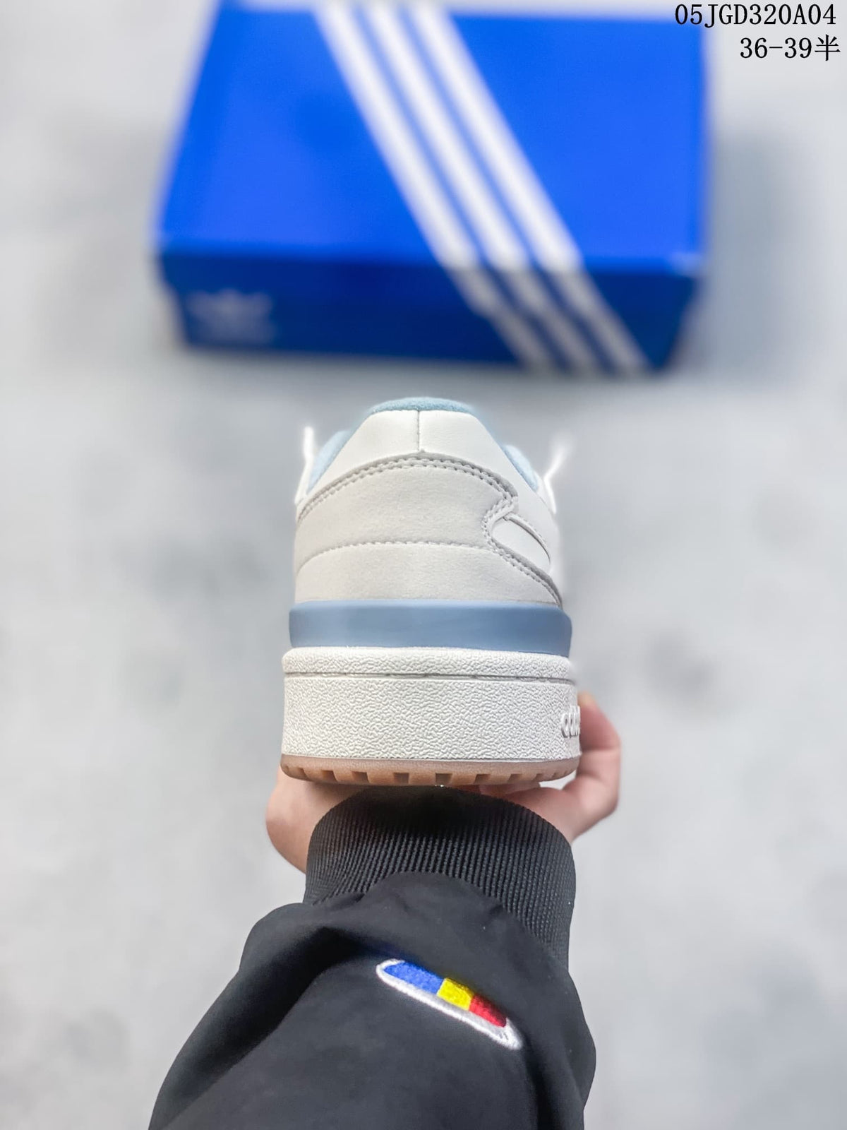 Rear view showing the blue heel accent and layered low-top design