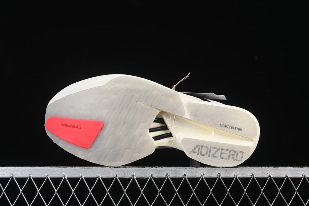 Underside view showing the patterned outsole, coral heel insert, and Adizero markings.