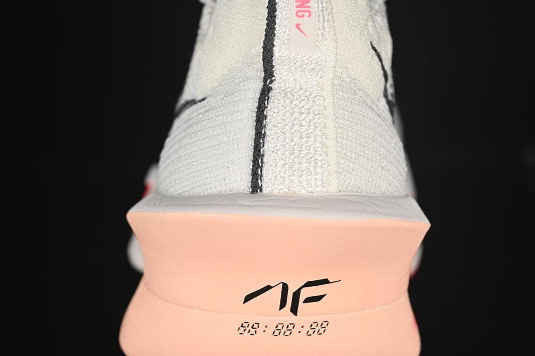 Rear view showing the shoe heel and coral-toned sole