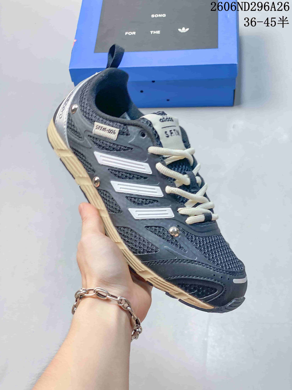 Angled side view showing the gray panels, light laces and metallic-tone accents