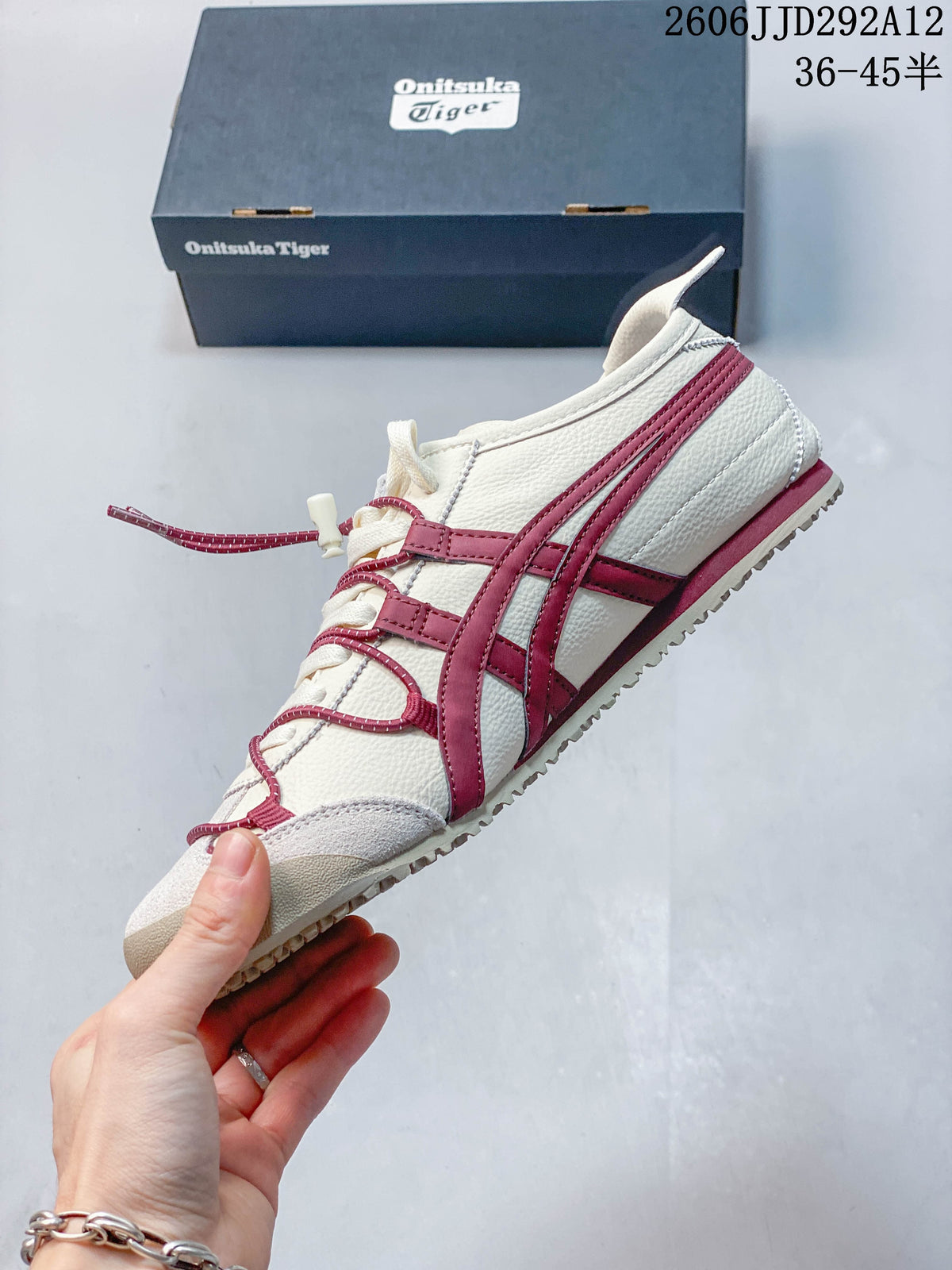 Side view of the cream sneaker with burgundy stripes and cord detailing