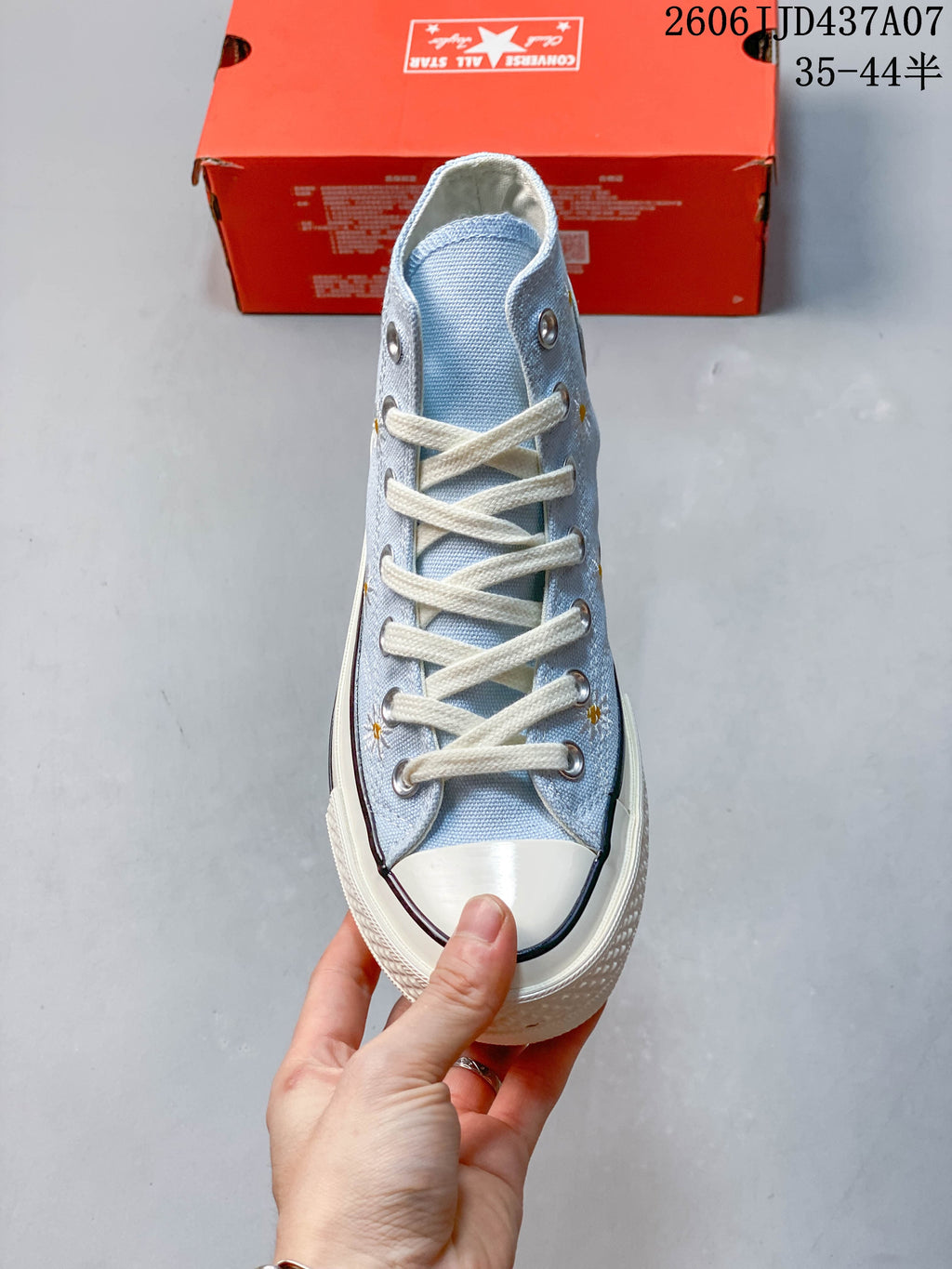 Front view showing cream laces, metal eyelets and a cream toe cap