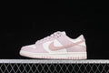 Side view of pale pink and white Nike Dunk Low sneakers