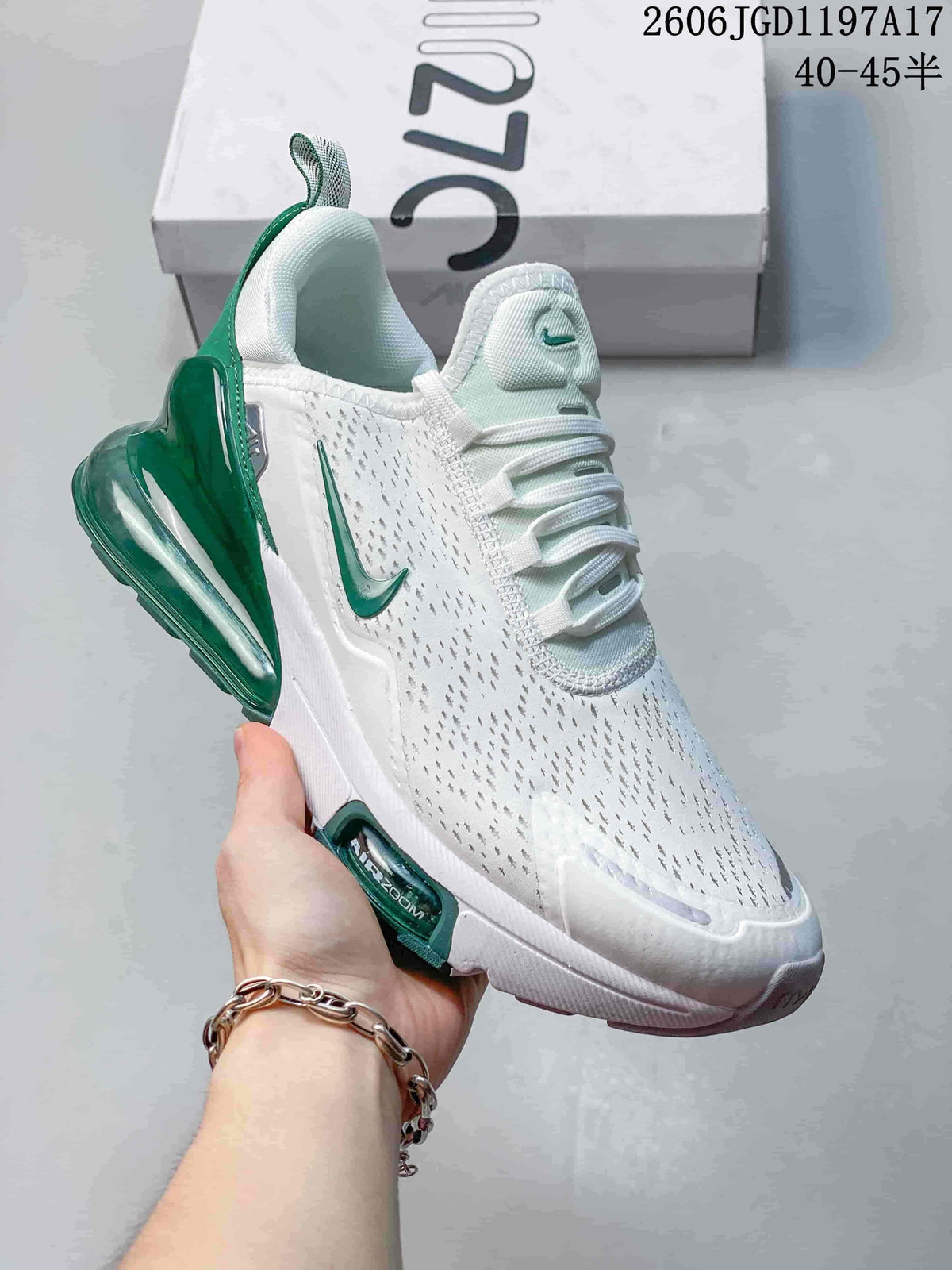 Close-up of a white Nike Air Max Pulse shoe with green accents and a visible heel air unit.