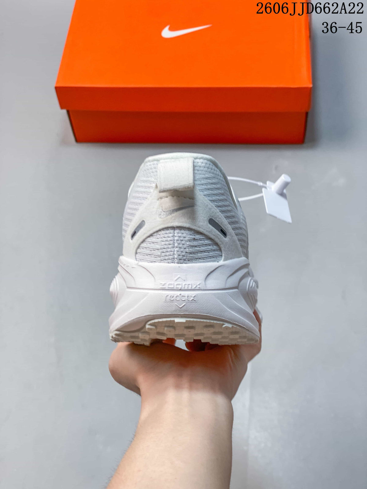 Rear view of a white running shoe with a sculpted heel