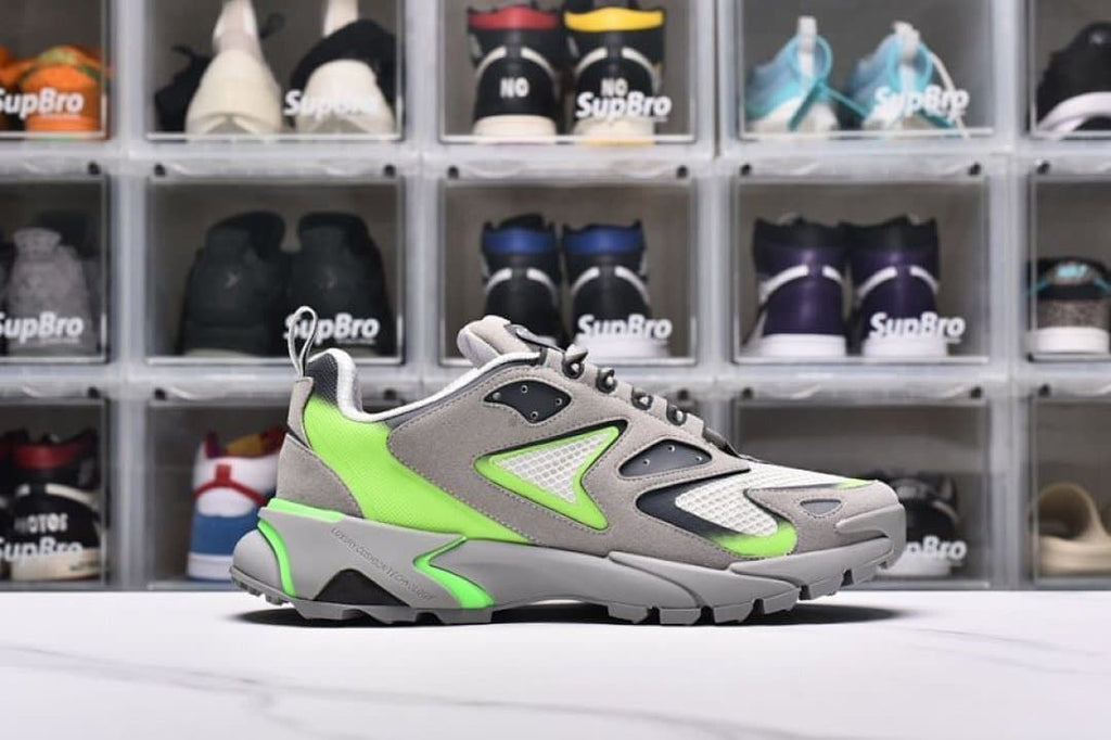 Outer side view highlighting the layered panels and green heel section