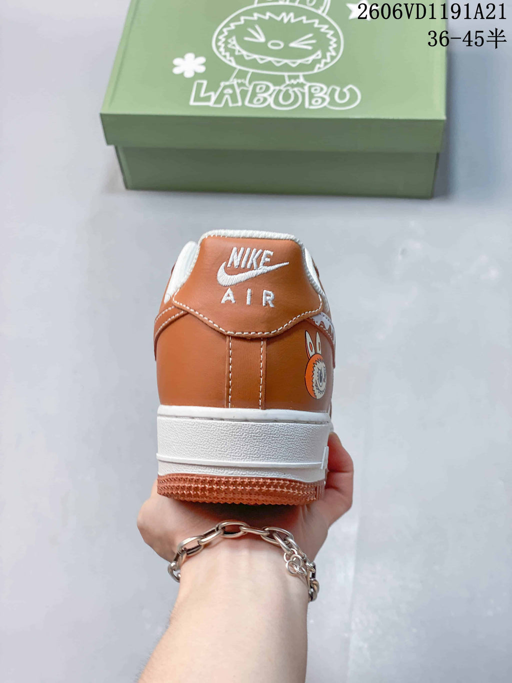 Rear view of brown-and-white sneaker with Nike Air branding and character graphic