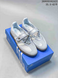 Pair of pale Adidas Samba Jane sneakers with Mary Jane straps, shown on a blue shoe box.