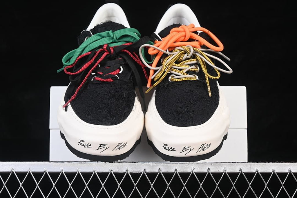 Front view showing black uppers, white soles and contrasting laces