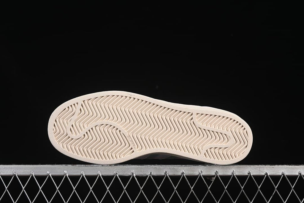 Underside view showing the patterned off-white outsoles