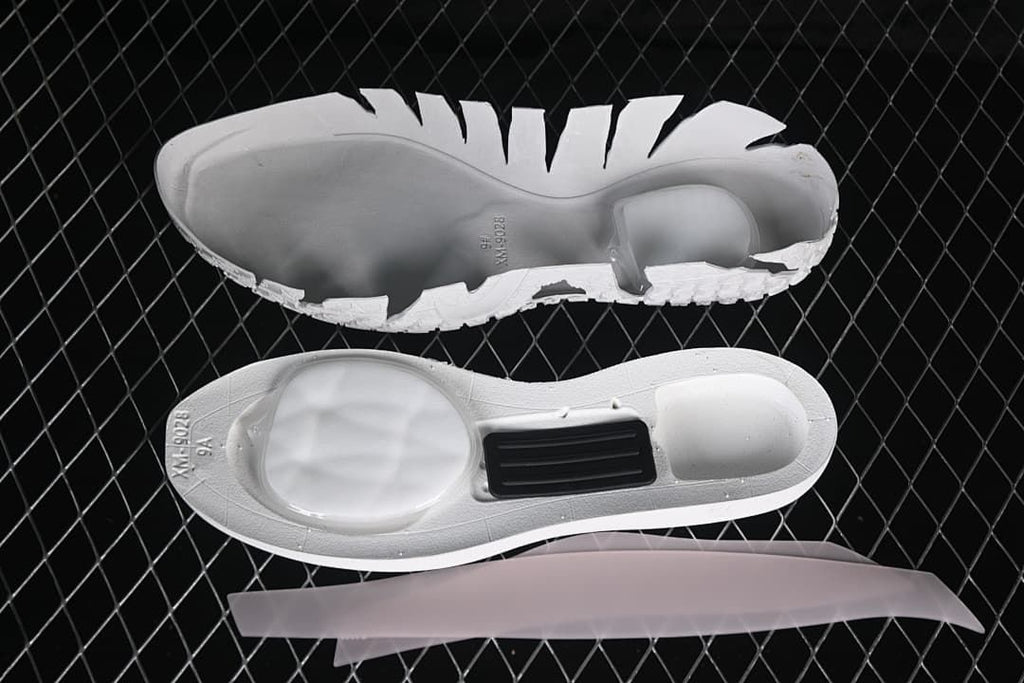 Disassembled shoe sole components displayed against a dark background