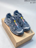 Pair of dark gray and black Salomon XT-6 GTX sneakers with silver accents, shown on a shoe box