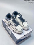 Pair of white and navy MLB low-top sneakers with graphic side detailing, shown on a box