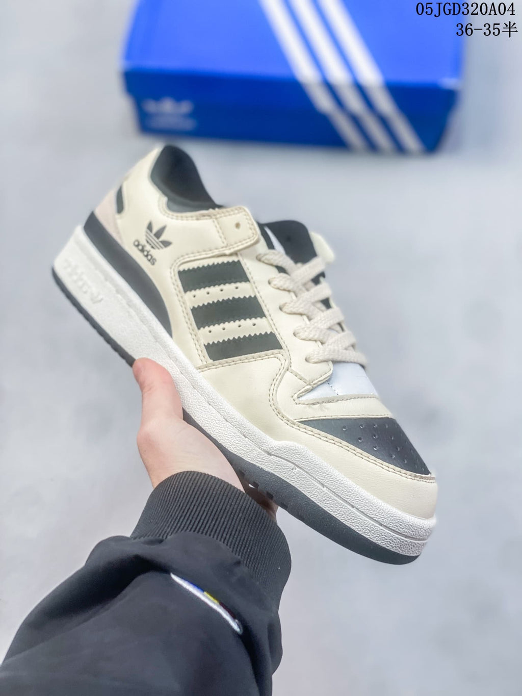 Angled side view of a cream and black Adidas Originals Forum 84 sneaker.