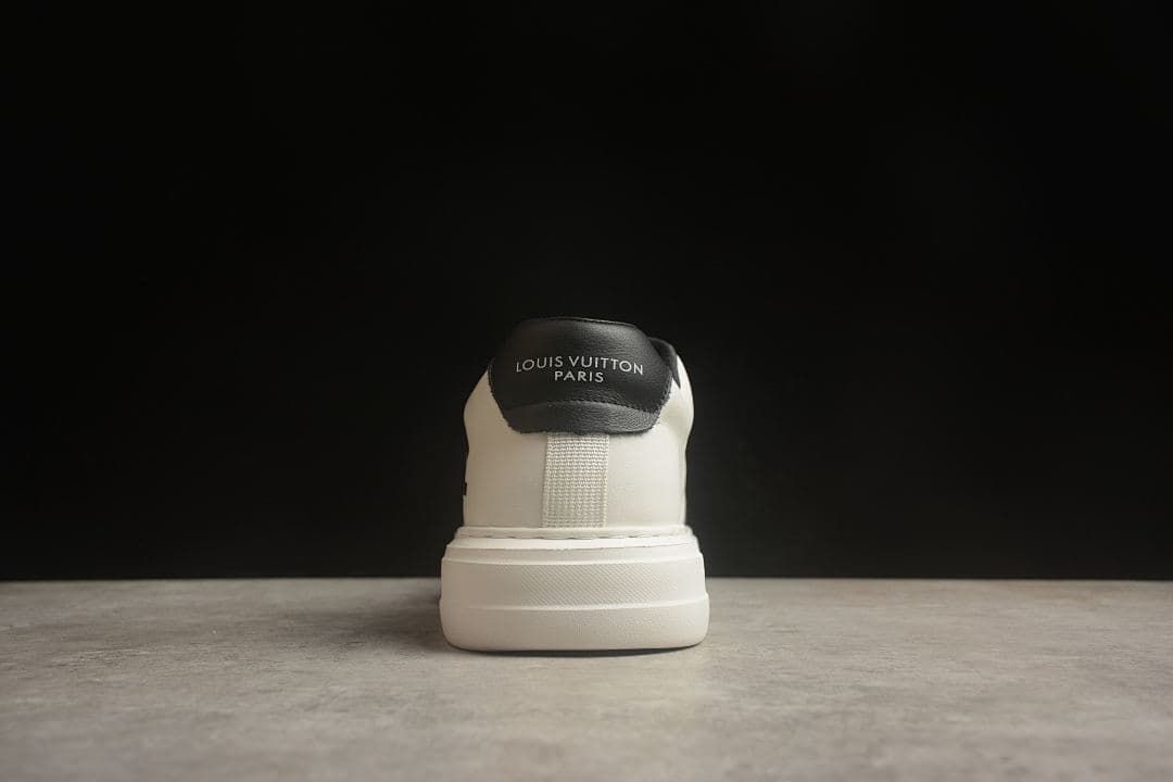 Rear view of one sneaker with text on the black heel panel