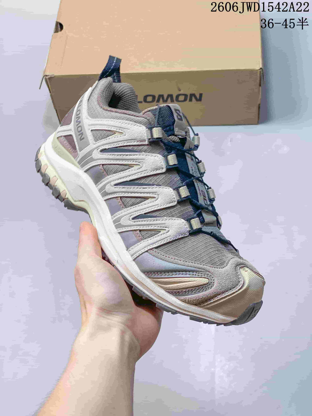 Angled side view of a Salomon XA Pro 3D sneaker in taupe and gray.