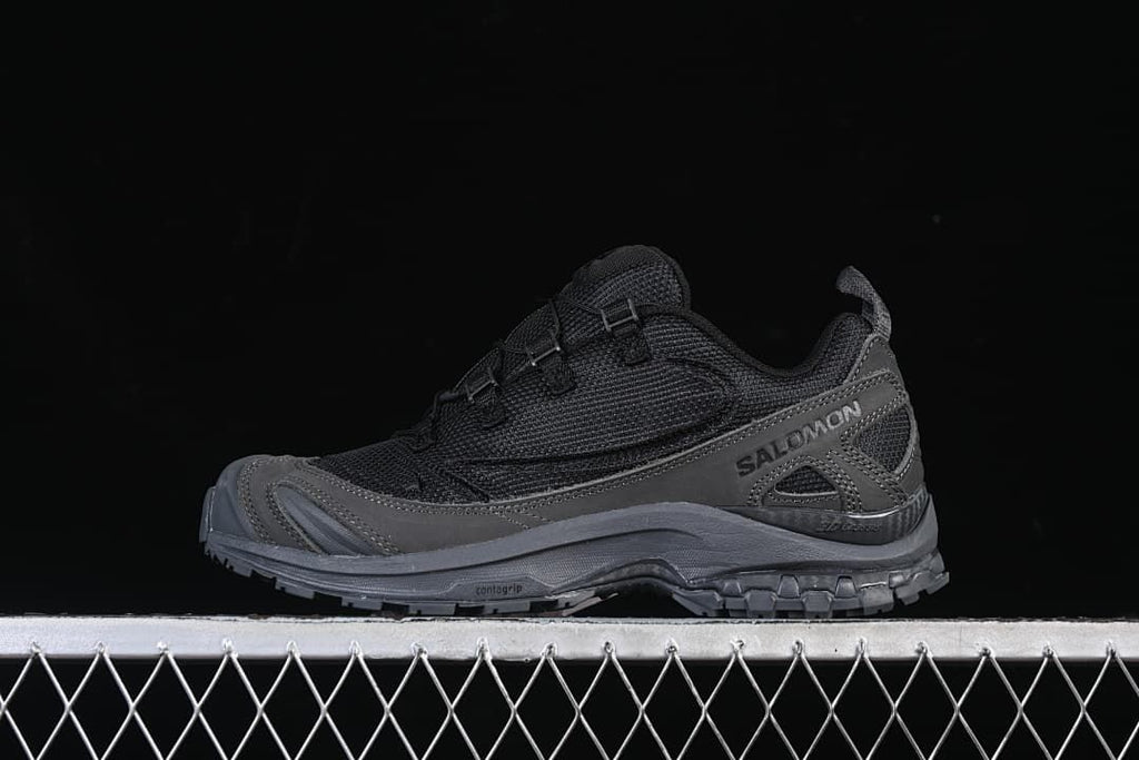 Side view of the black and dark grey shoe
