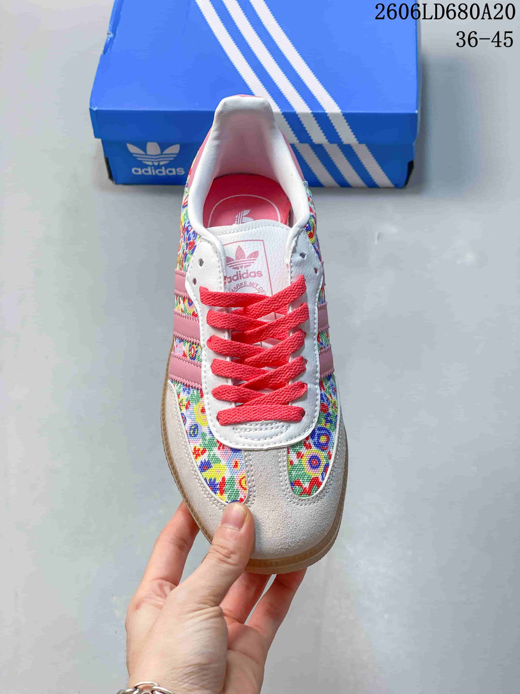 Top view showing coral laces, floral panels, and pink lining
