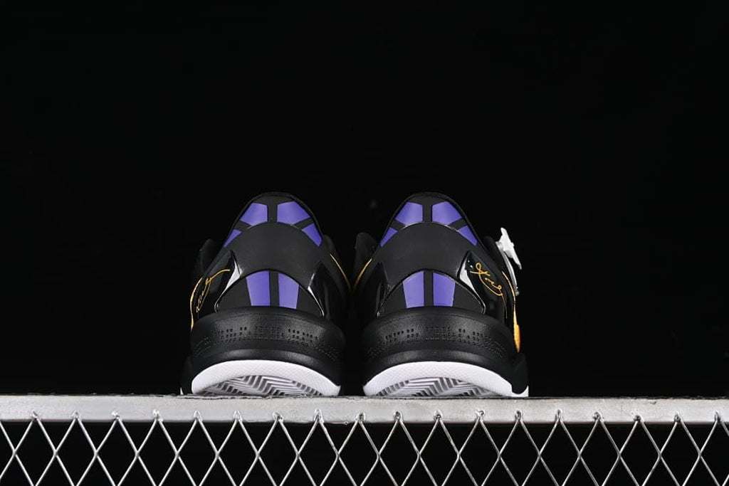 Rear view of both shoes showing purple heel accents and black heel panels