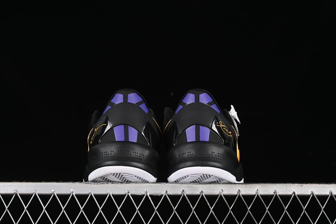 Rear view of both shoes showing purple heel accents and black heel panels