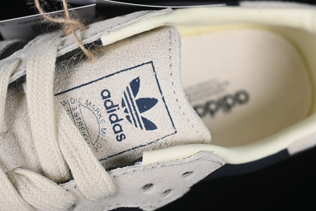 Close-up of the tongue label and cream-colored laces