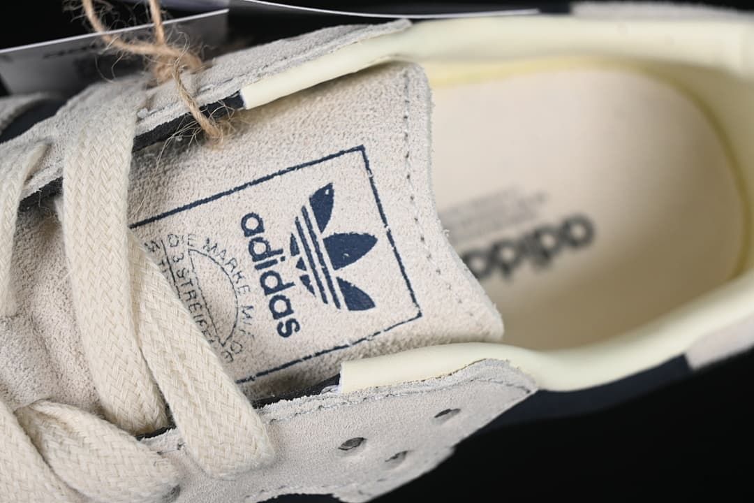 Close-up of the tongue label and cream-colored laces