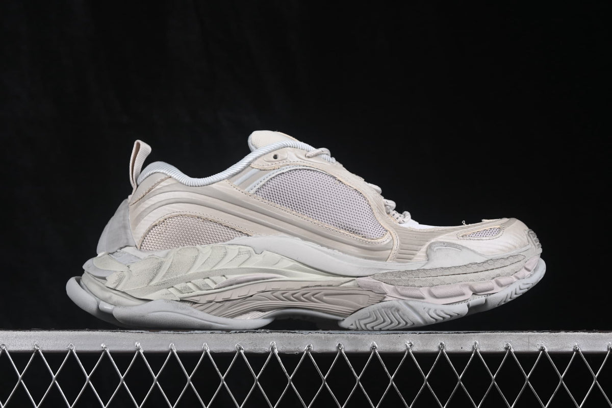 Opposite side profile of the cream and white sneaker showing mesh panels and the layered midsole.