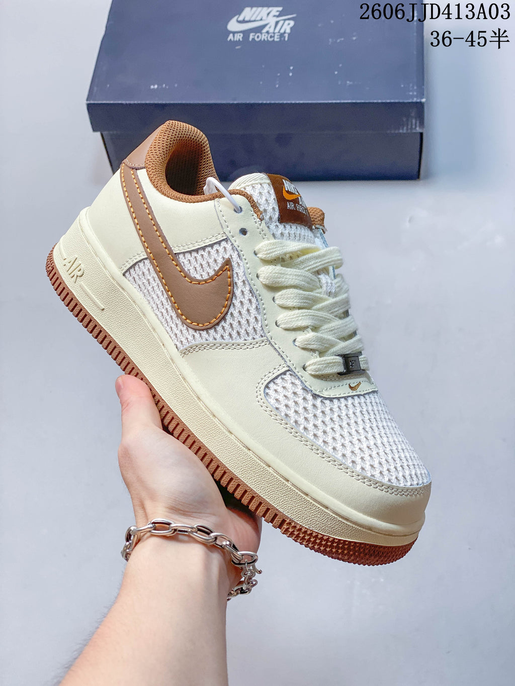 Side view of a cream-and-brown low-top sneaker with mesh panels and a gum-colored outsole.