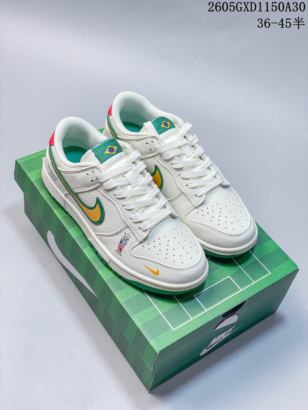 Pair of white Nike Dunk low-top sneakers with green and yellow accents, Brazil flag tongue details, and a green football-themed box.