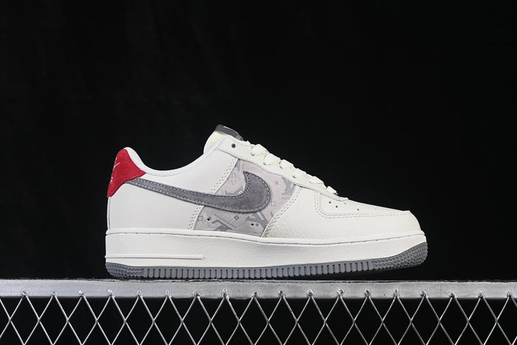 Side profile showing a gray patterned panel, gray Swoosh, and red accents