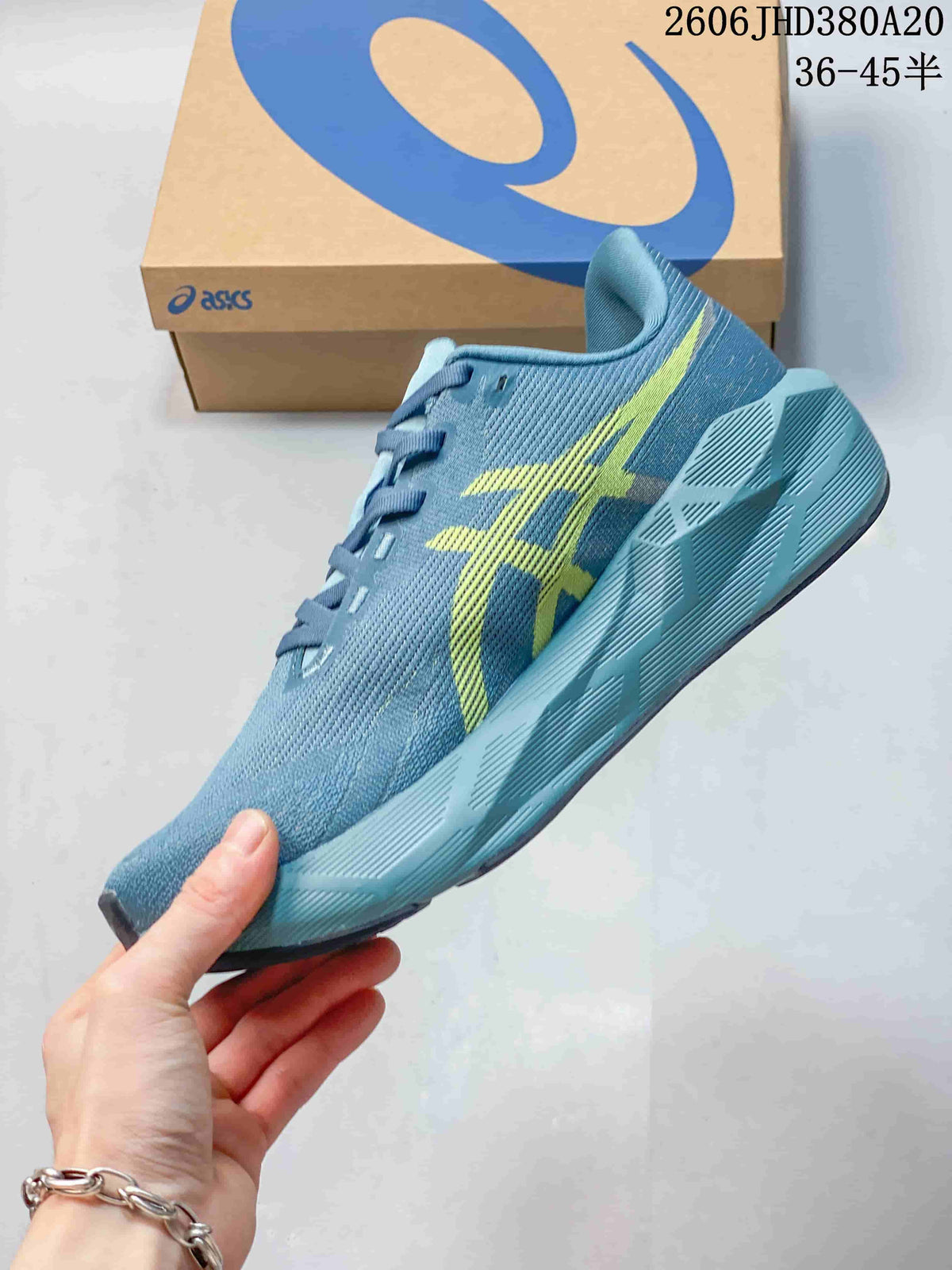 Side view of the blue ASICS Novablast 6 running shoe with yellow accents