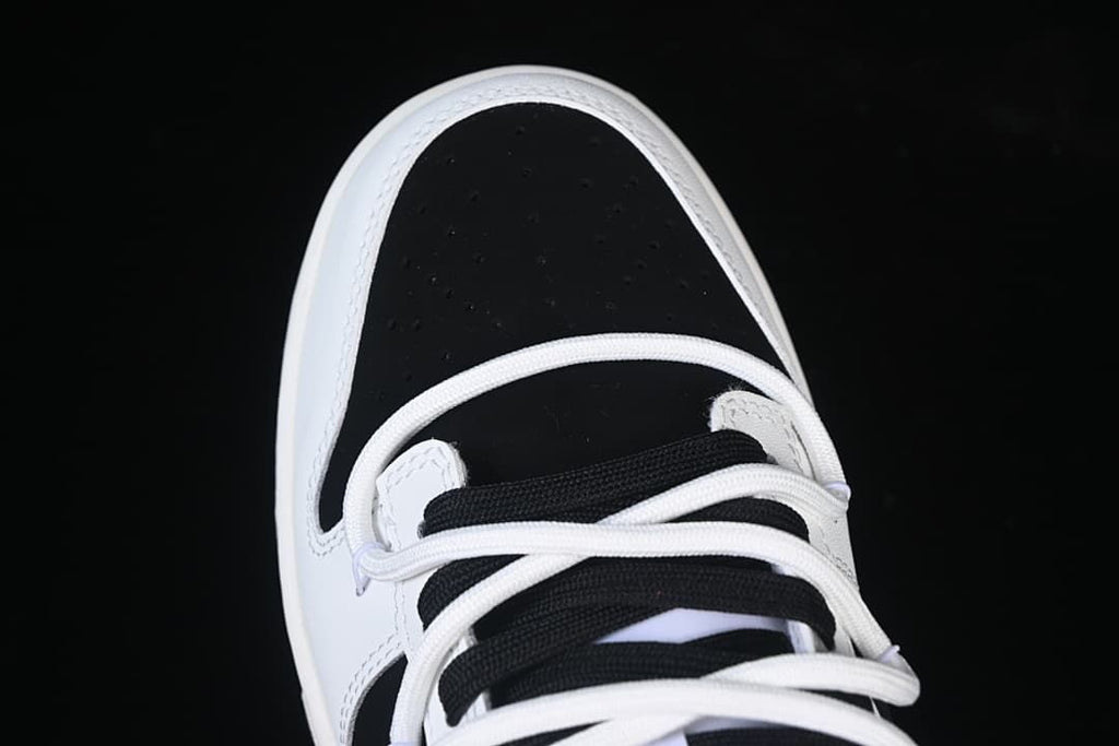 Top-down detail of the black perforated toe and lace area