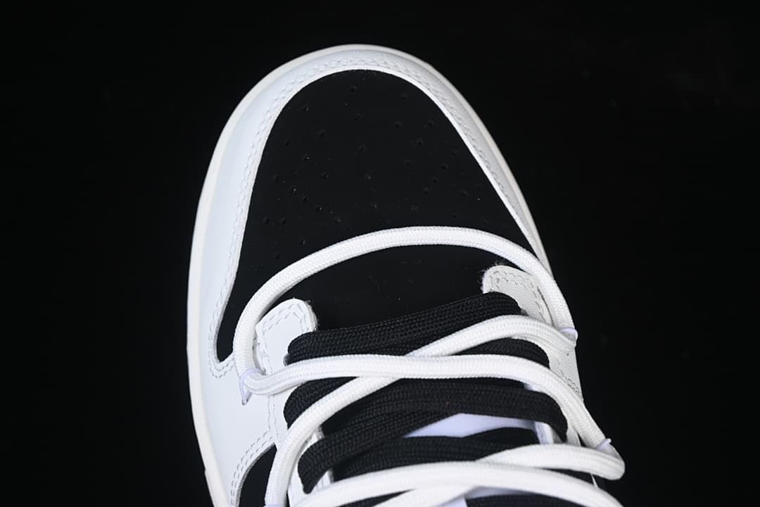 Top-down detail of the black perforated toe and lace area