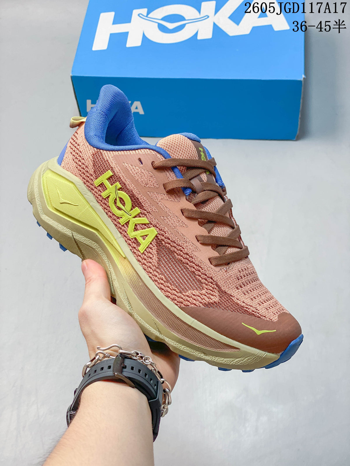Dusty rose Hoka Mafate Speed 2 shoe with brown laces, blue collar accents and a pale yellow-green midsole section.