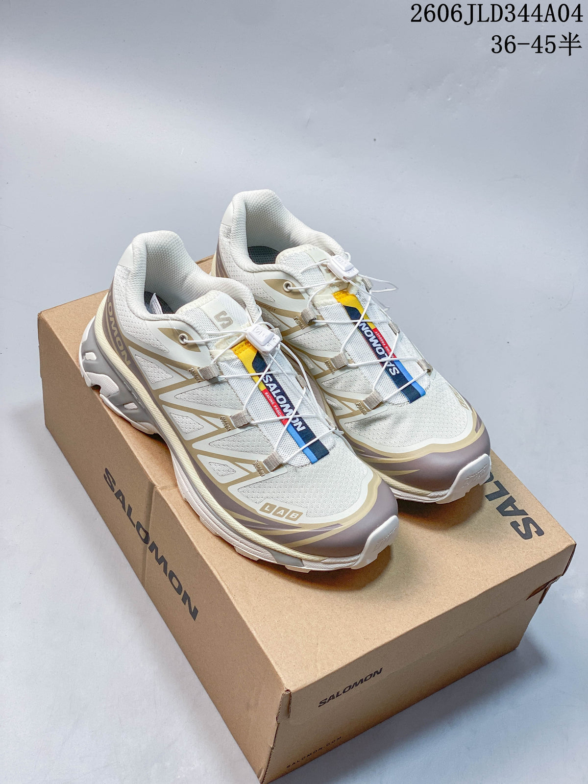 Pair of white and taupe Salomon XT-6 trail running shoes on a branded box.