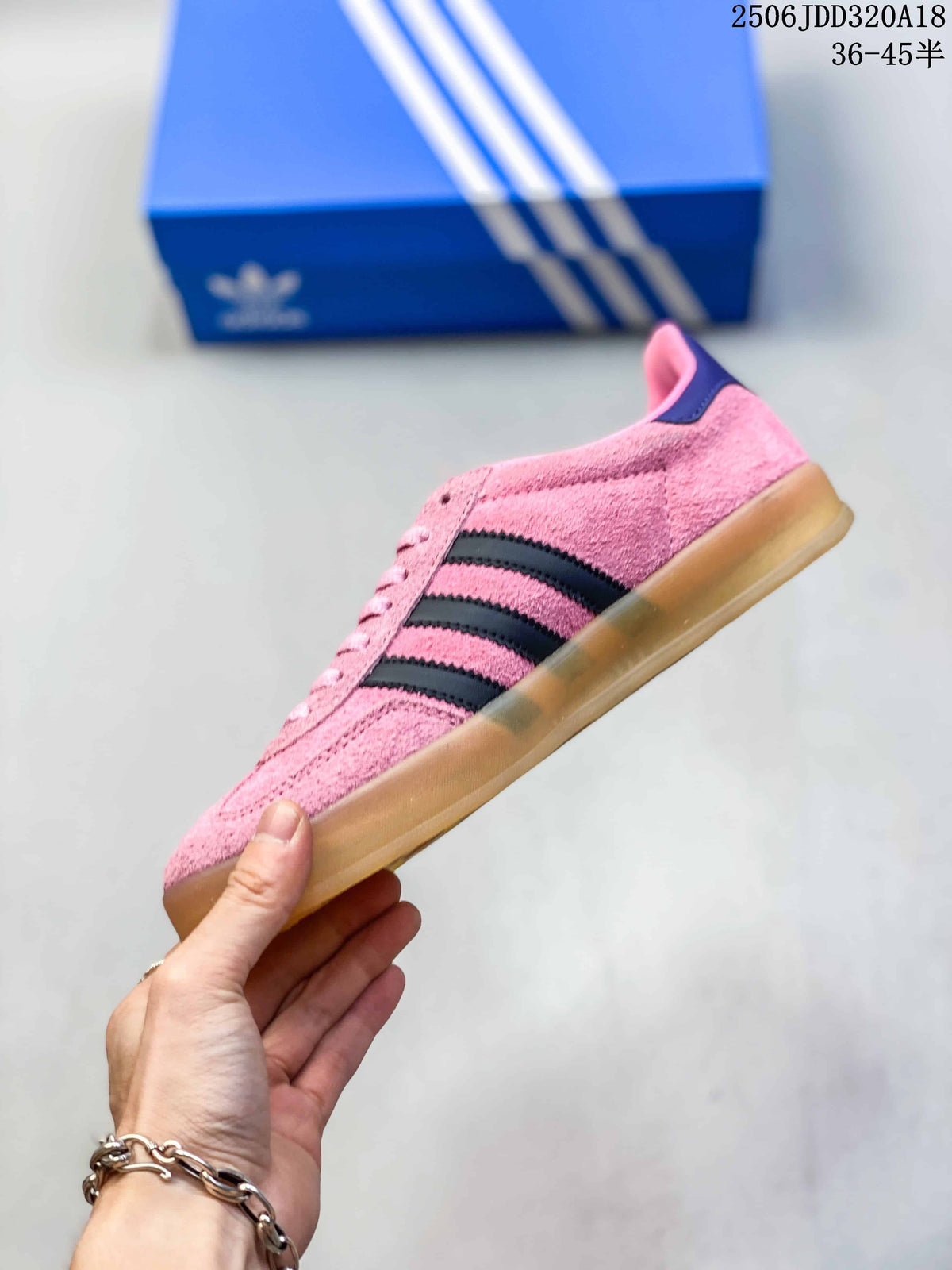 Side profile of the pink sneaker showing three dark stripes and a gum-colored sole.