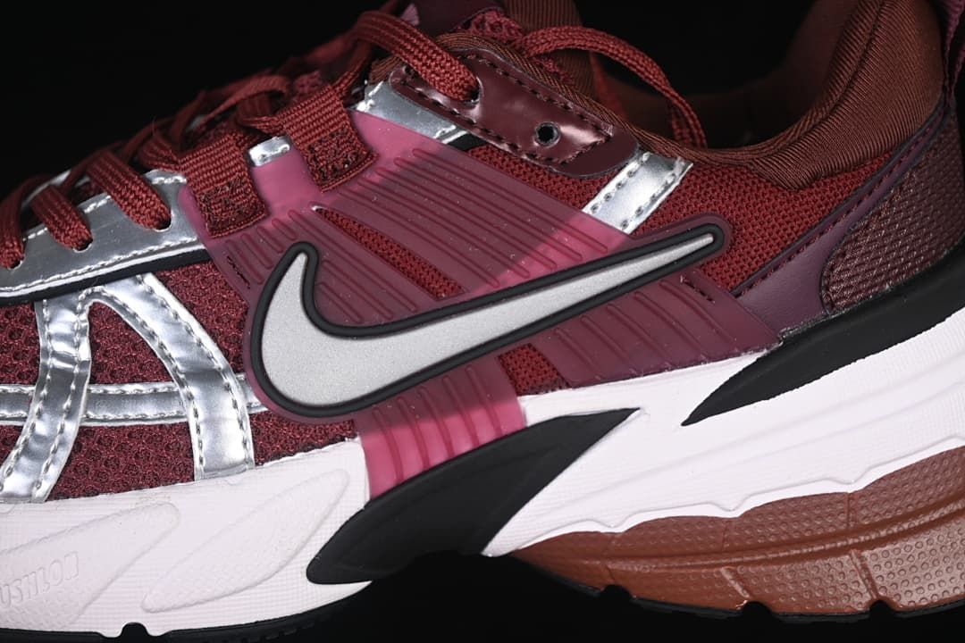Close-up of the side Swoosh, burgundy panels, silver overlays, and sole