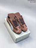 Brown and silver Puma Speedcat sneakers shown from above on a shoe box