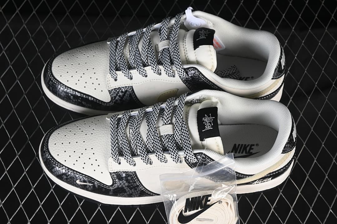 Top view of the Nike SB Dunk Low pair with patterned laces, perforated toe boxes, and an extra set of light-colored laces.